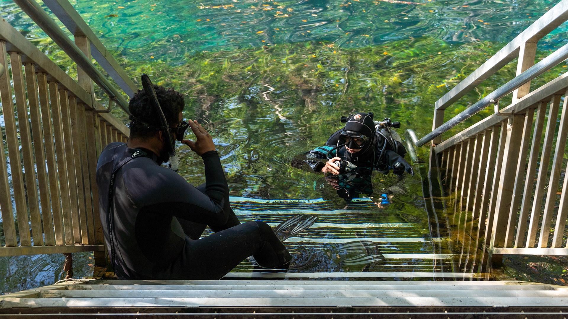 Baratunde and Chelsea in snorkling gear in the water